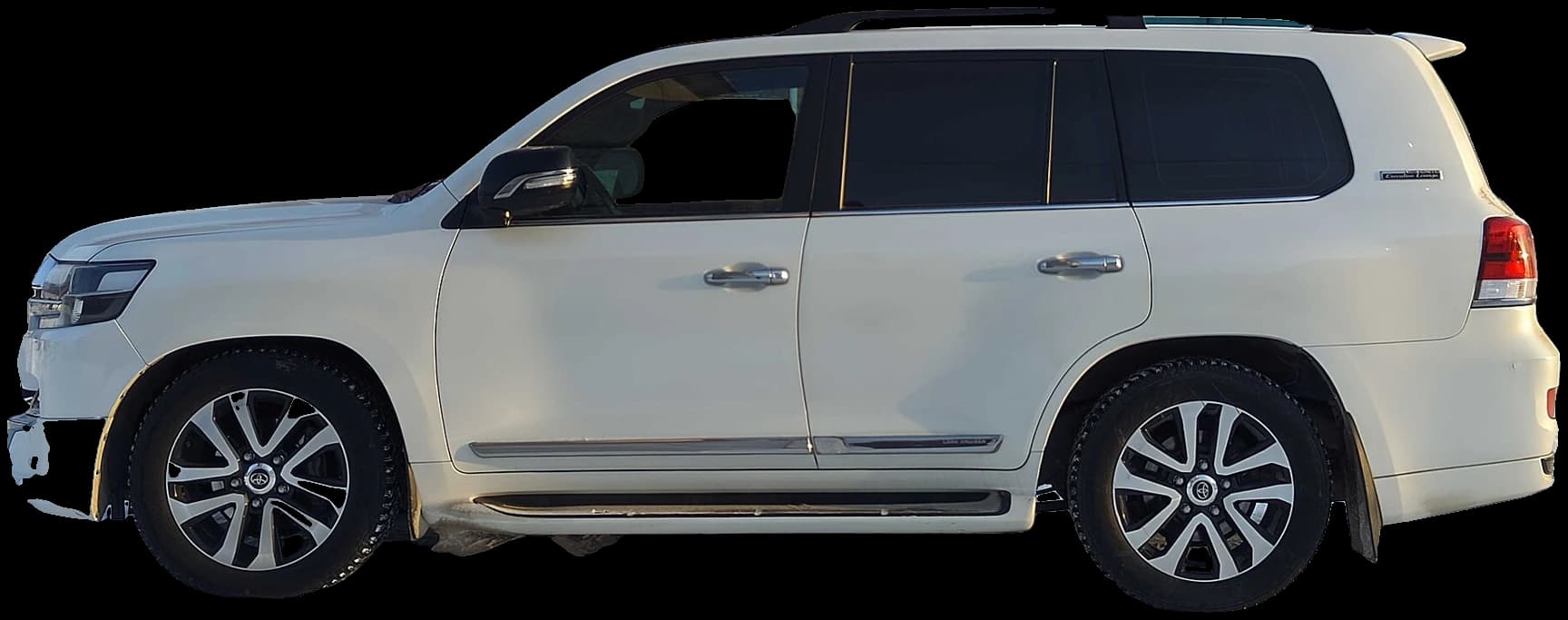 White Toyota Land Cruiser standing in a lit garage bay